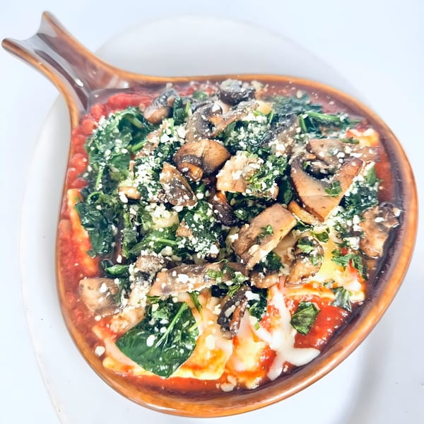 Ma Ma Fia's East baked ravioli with tomato sauce, spinach, mushrooms, and parmesan cheese.